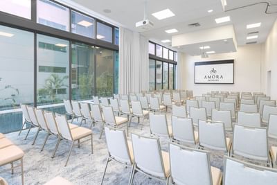 White seating arranged with screen in a meeting room at Amora Hotel Brisbane
