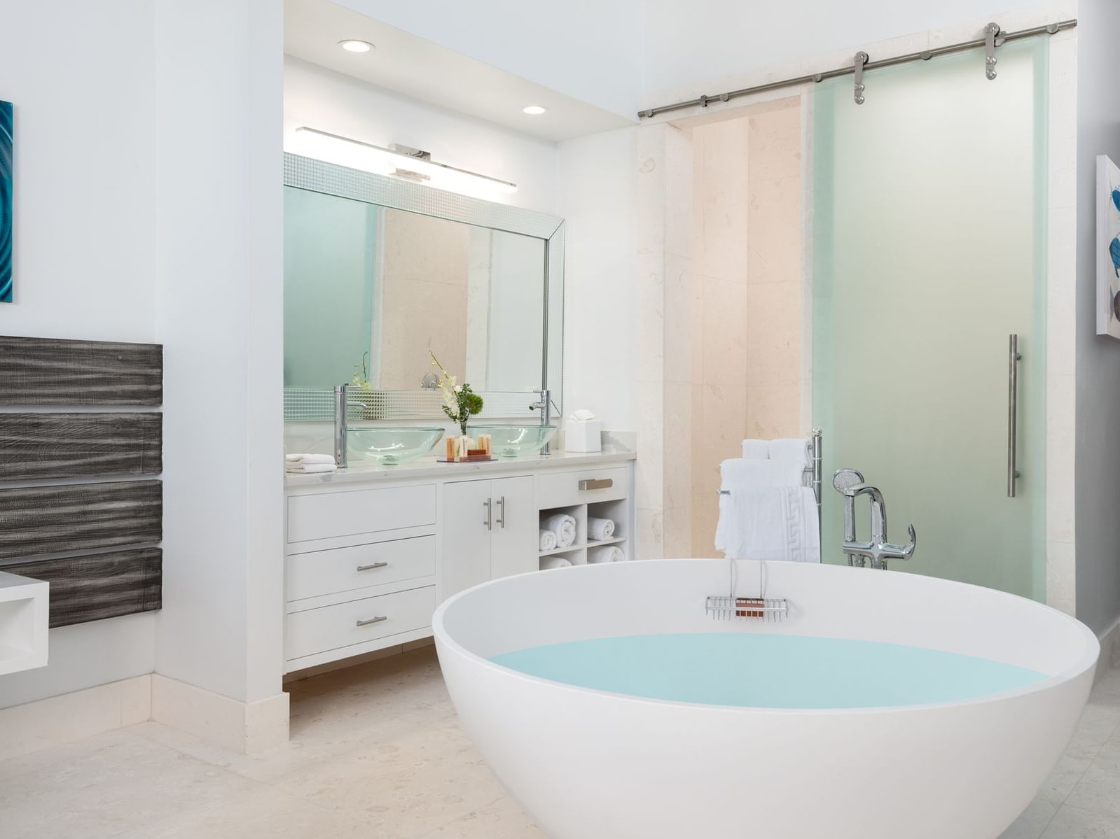 Bathtub, wash basin, and the shower room in King Superior with Tub Marina Views at Zenza Hotel