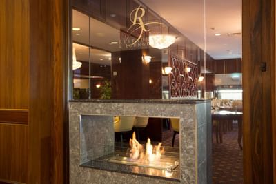 The cozy and elegant fireplace at The Walnut restaurant and bar in the Royal on the Park Hotel