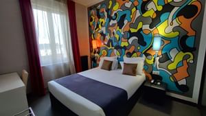 High angle view of a bedroom with wall arts at Originals Hotels