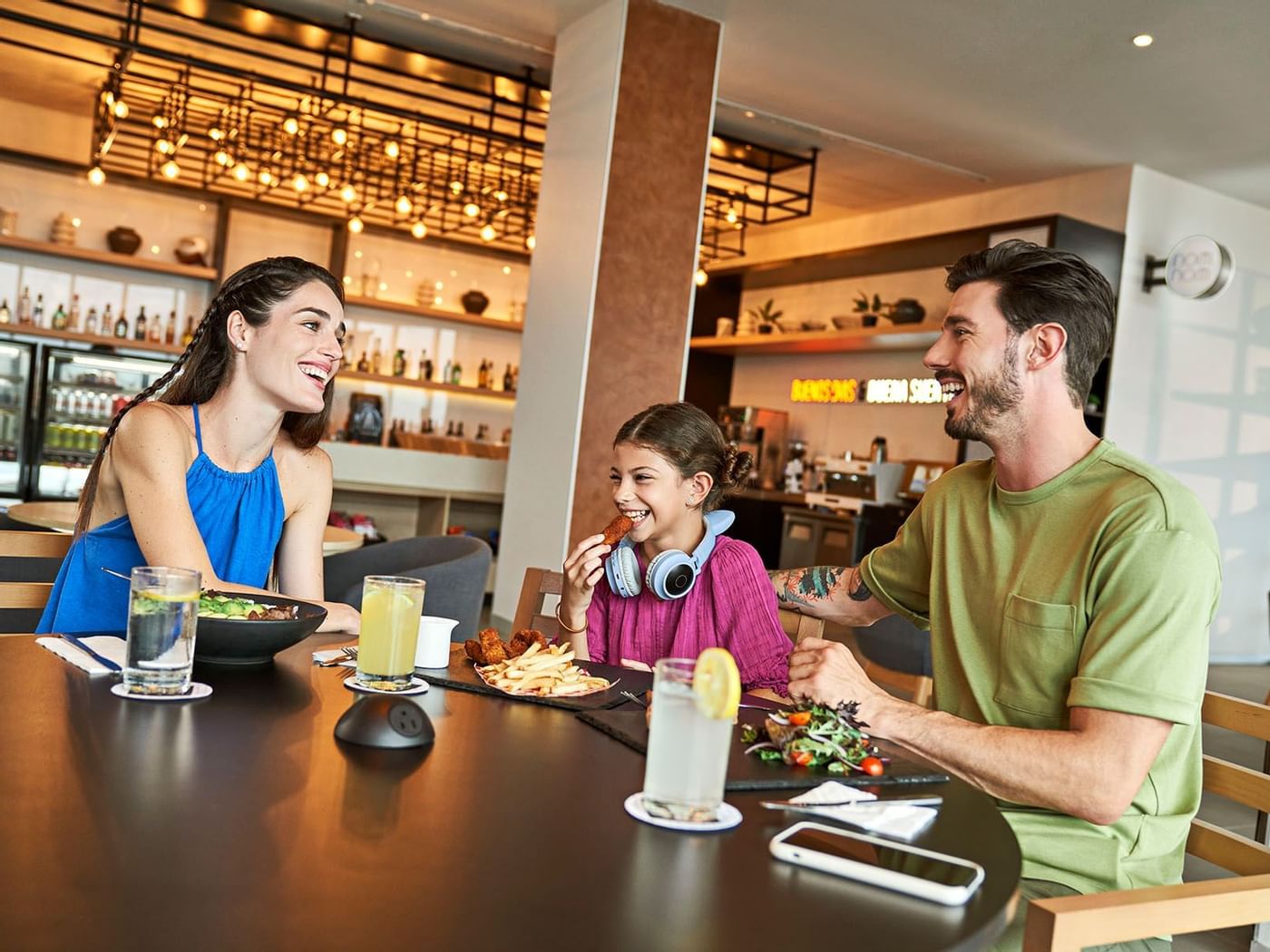 Family enjoying meals in a Restaurant at IOH Freestyle Hotels