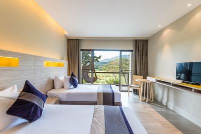 Beds in Deluxe Mountain View Room at Chatrium Golf Resort