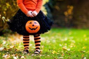 Girl holding a Halloween candy tub, Rosen Inn International