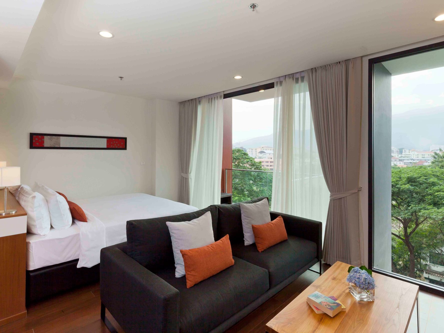 King bed and sofa set in Deluxe Room at Eastin Hotels