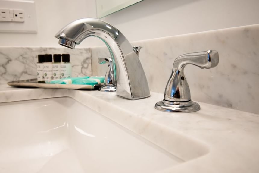 Washbasin, silver faucet & bathroom amenities at Bayside Inn Key Largo