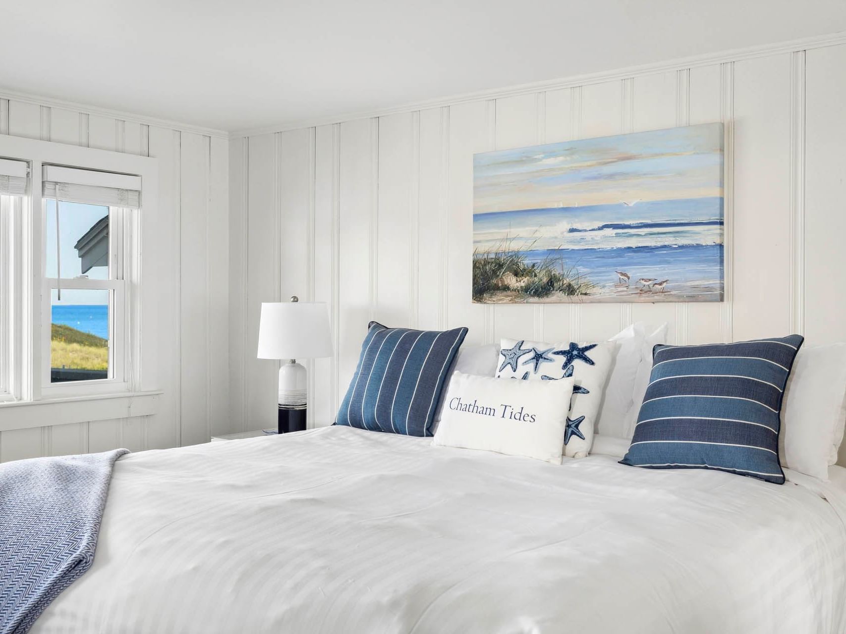 Nightstand by the double bed in Risingtide Oceanview King Efficiency at Chatham Tides Resort