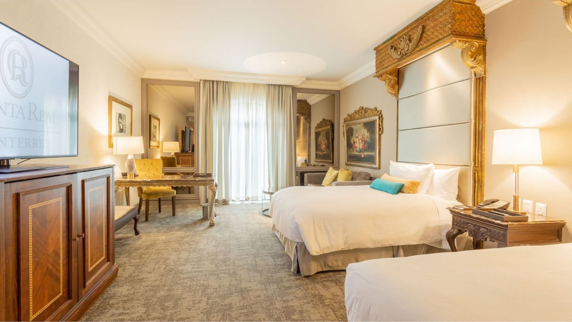 View of 2 Double Grand Class featuring gold-framed mirrors and a classic workspace station at Quinta Real Monterrey