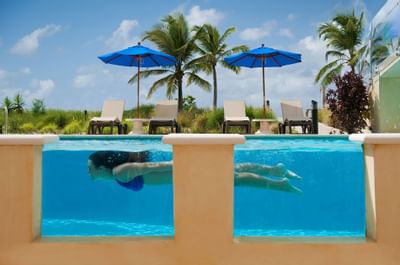 Woman swimming in a pool at Windsong Resort On The Reef