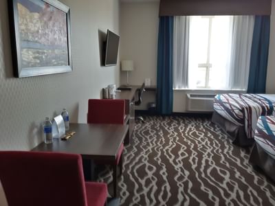 Two Queen Suite interior with a working desk at Encore Suites Grande Prairie