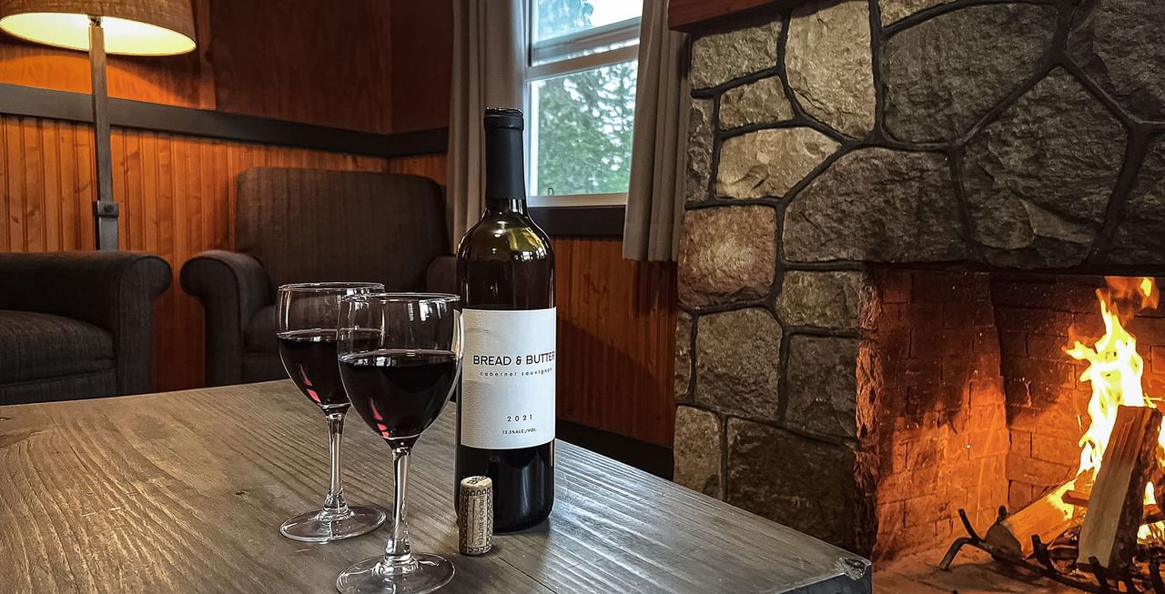 Fireplace, sitting area, and table with glasses of wine