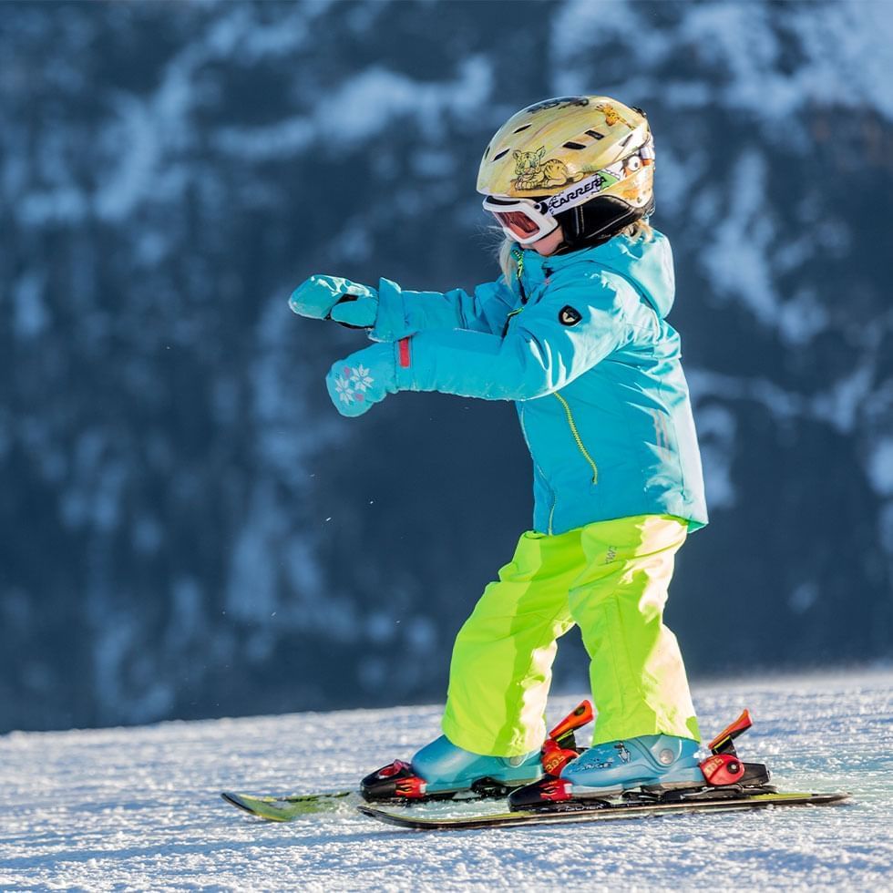 A kid in ski wear near Falkensteiner Hotel Cristallo