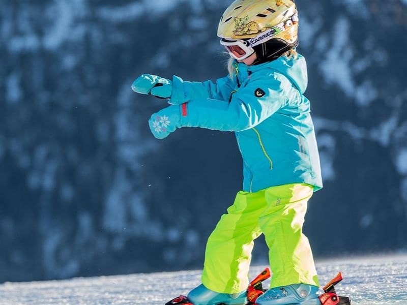 A kid in ski wear near Falkensteiner Hotel Cristallo
