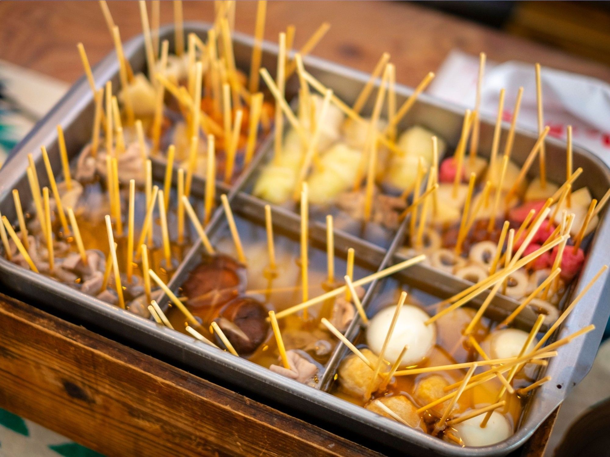 Japanese winter dish featuring various ingredients simmered in a dashi-based broth served on a table at Grand Park Otaru