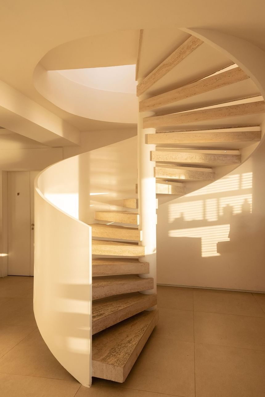 Modern white themed spiral stairway at Janeiro Hotel