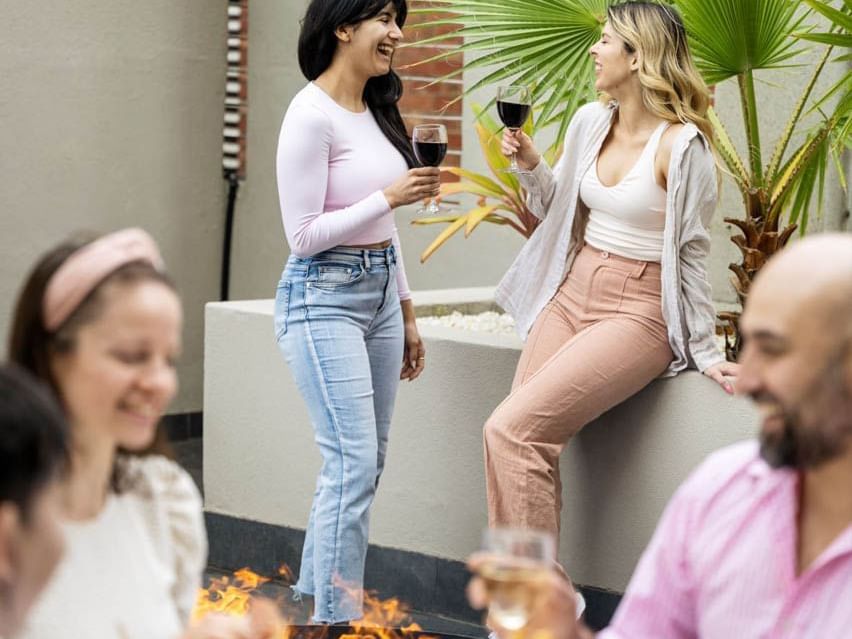 People lounging & enjoying drinks in a terrace at Grand Chancellor Adelaide