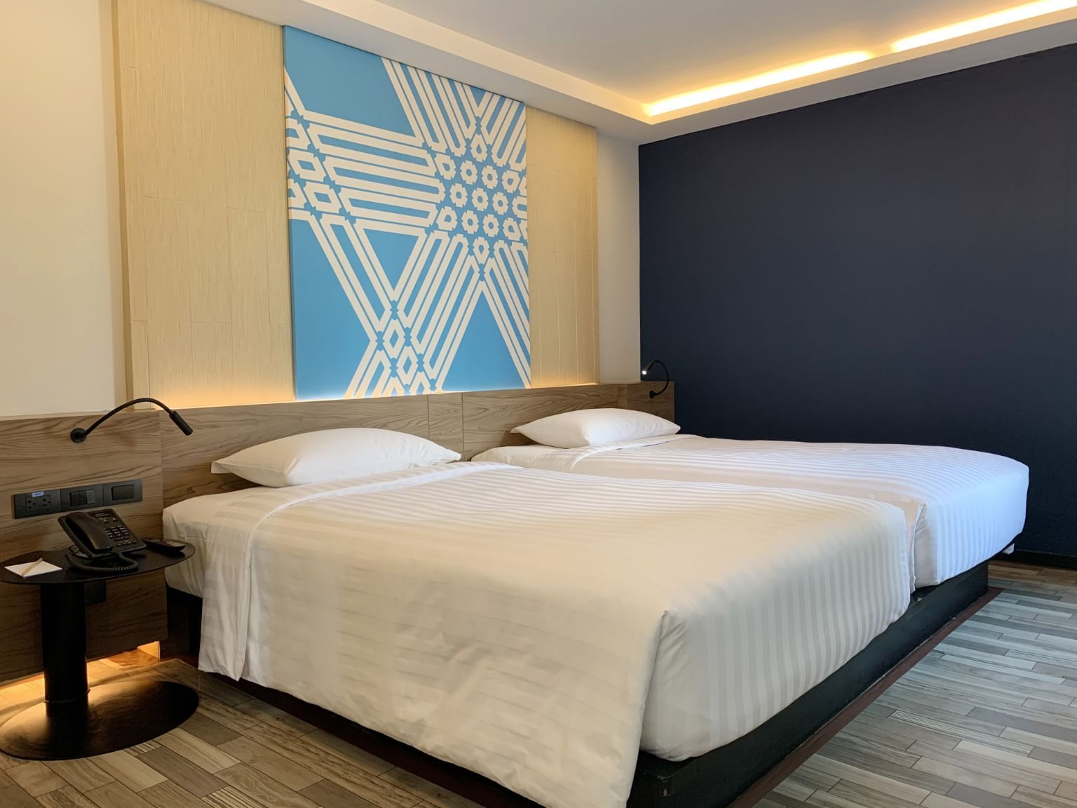View of twin beds in Deluxe Room at Maitria Mode Sukhumvit 15