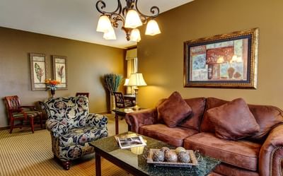 Vintage leather sofas & chandelier in Executive Suite lounge area at The Wildwood Hotel