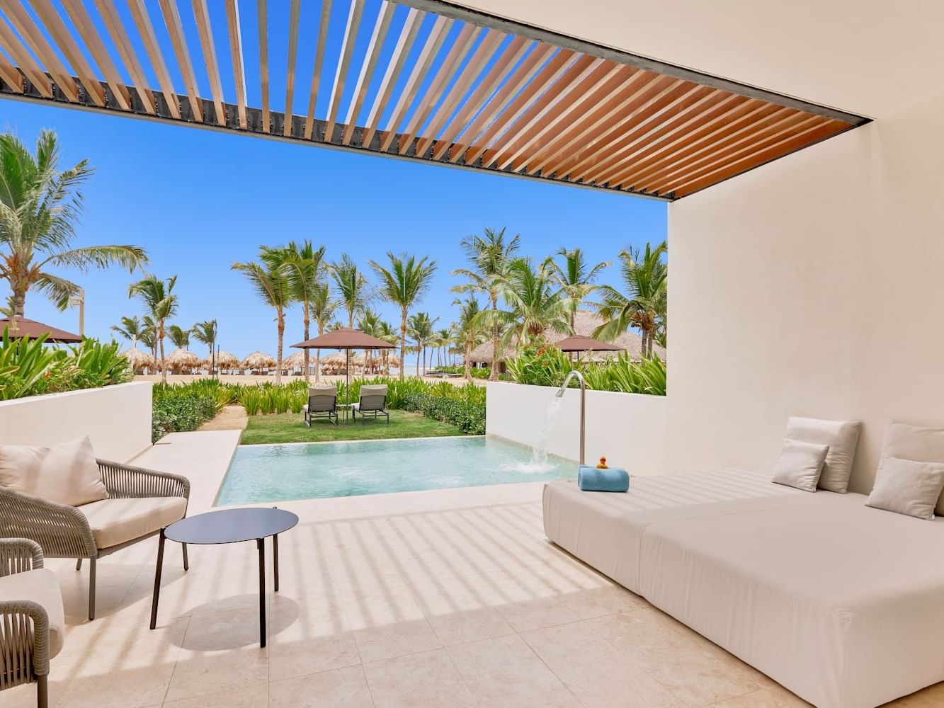 Outdoor pool with lounge area in Tierra Suite at Live Aqua Punta Cana
