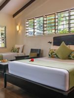 Studio Villa at Tokatoka Resort in Nadi with two beds, tropical decor, and wooden floors