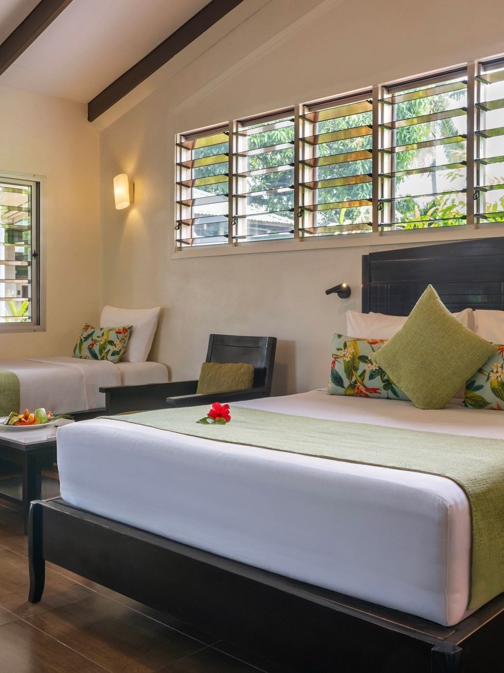 Studio Villa at Tokatoka Resort in Nadi with two beds, tropical decor, and wooden floors.