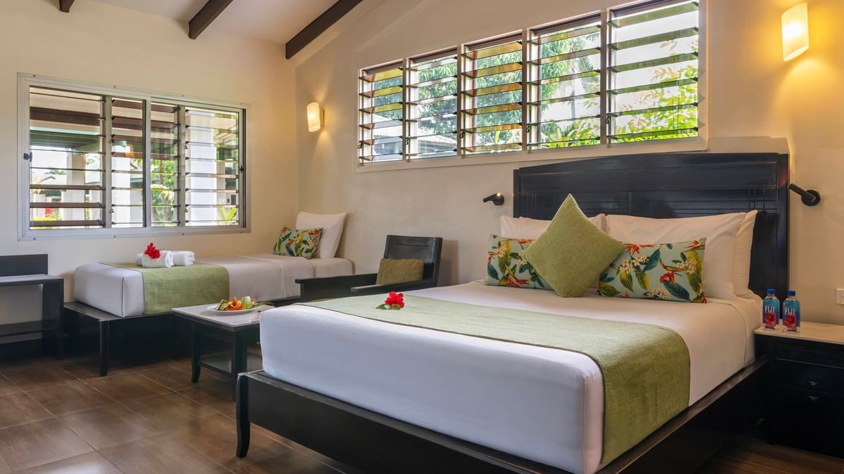Studio Villa at Tokatoka Resort in Nadi with two beds, tropical decor, and wooden floors.