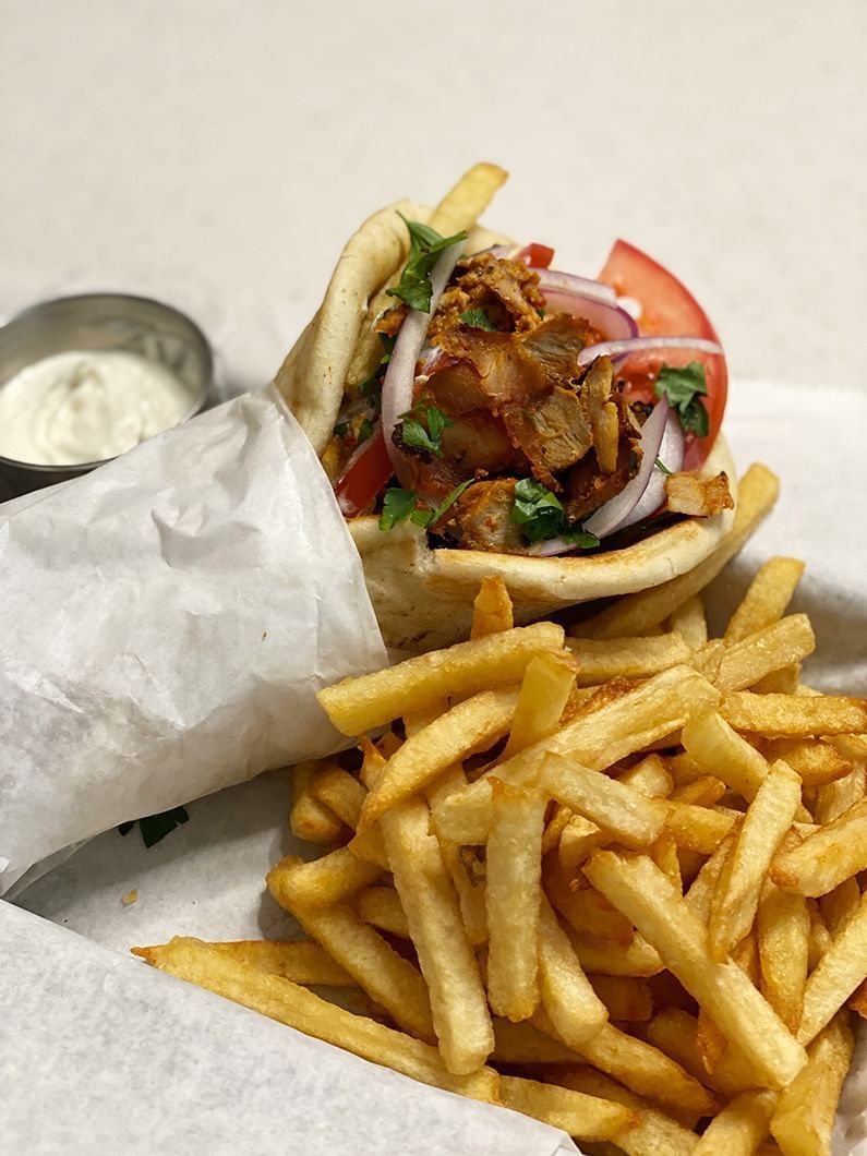 Image of a gyro sandwich with french fries