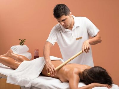 Lady getting bamboo massage in spa at Ana Hotels Europa