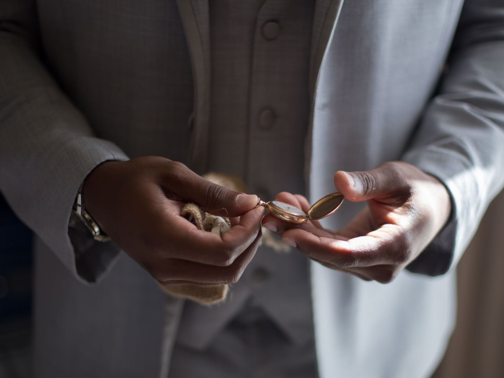 Close-up of a groom holding jewelry at Haven Riviera Cancun