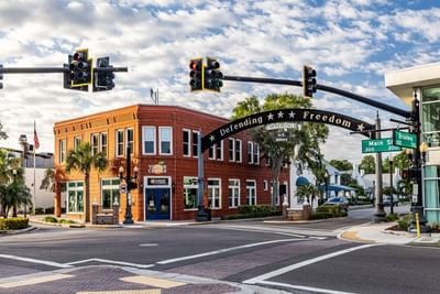 Street with traffic lights and buildings near Grant Street Inn in Dunedin FL