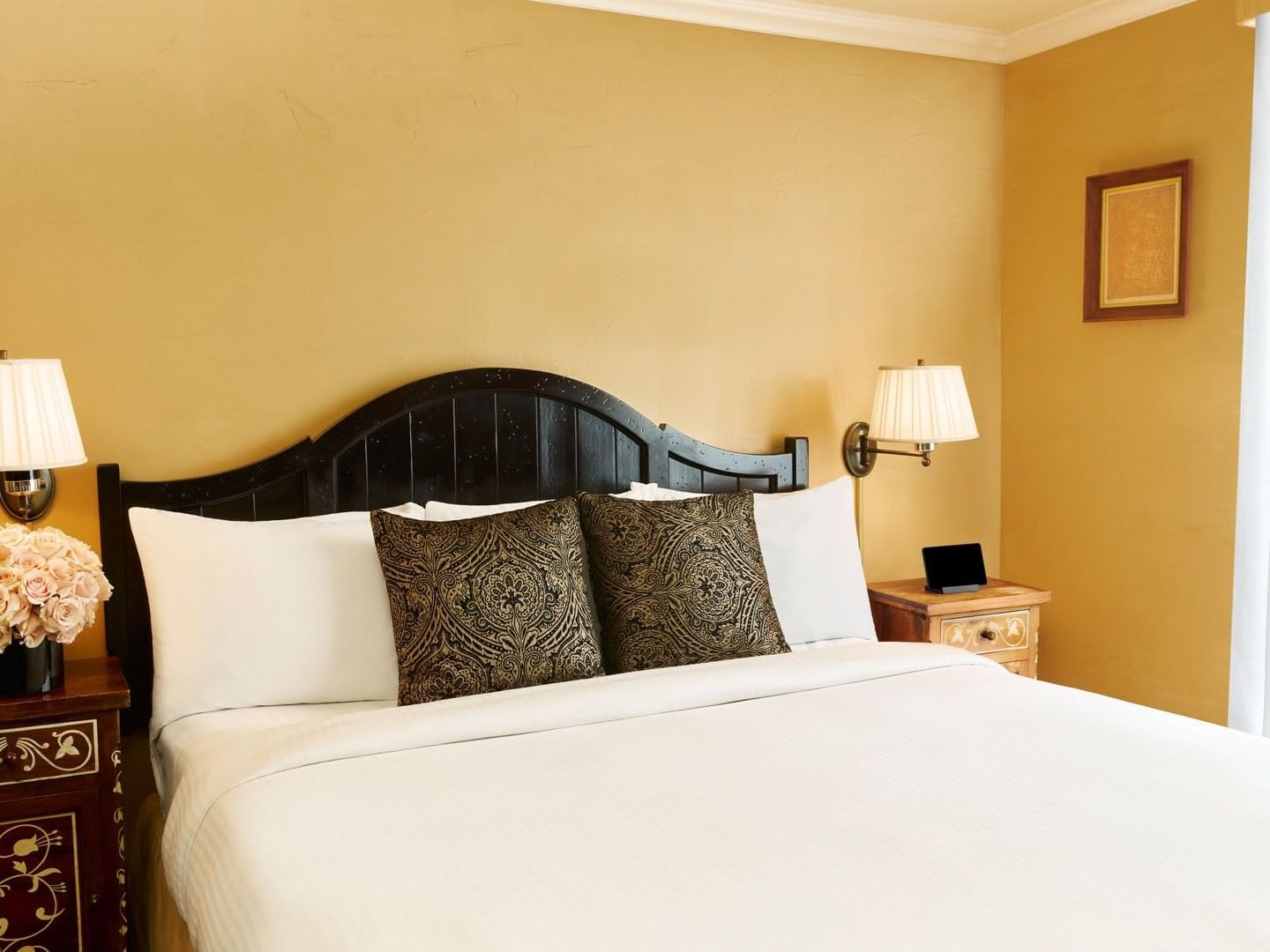 Executive Suite featuring white bed with black headboard and side lamps at Petit Ermitage