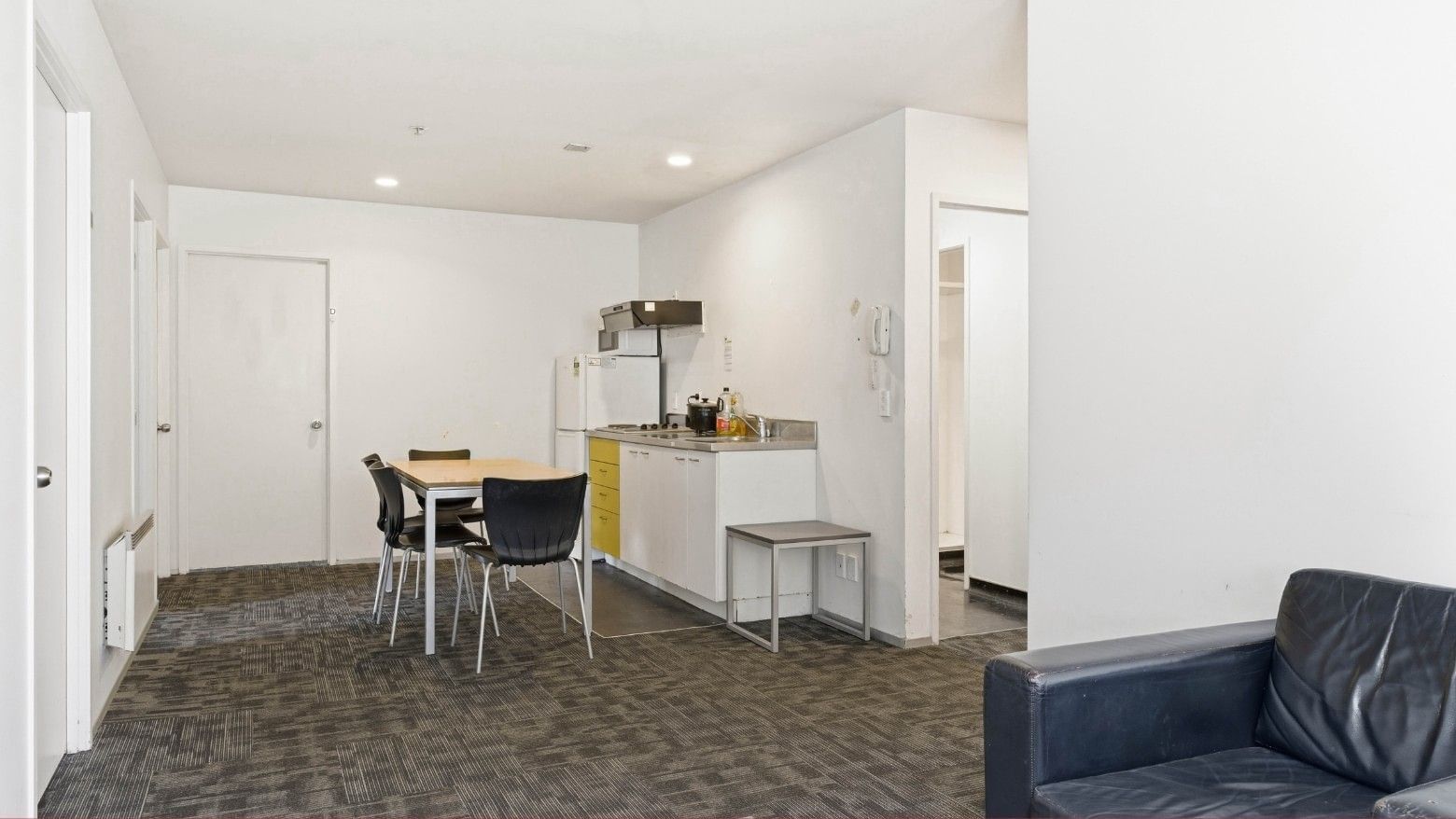Modern interior of Student Living Auckland – Anzac with dining area and kitchenette.
