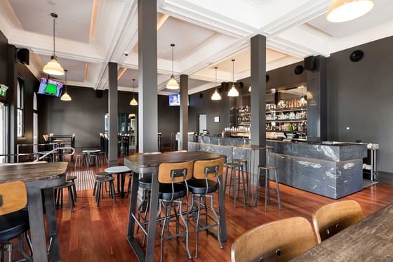 Lounge area with high stools in De Baun & Co. Pub at Melbourne Hotel Perth
