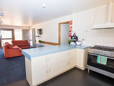La Trobe University - Terraces shows a kitchen and living area with couch and stove.