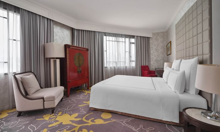 Suites with a king bed & comfy chair at Paradox Singapore