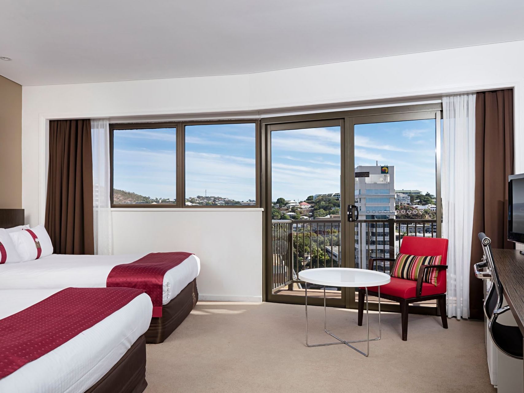 Beds & lounge in Standard Twin with a balcony at Grand Chancellor Townsville