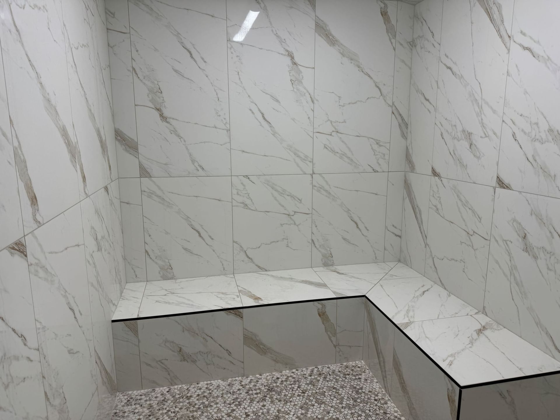 Luxurious marble-tiled steam room with integrated benches at the spa, Shangri-La Monkey Island