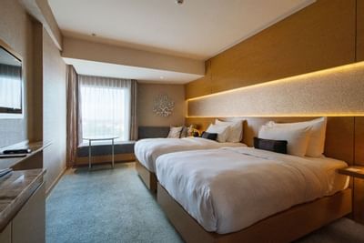 Interior of a room with twin beds at Vasa Hotel Surabaya
