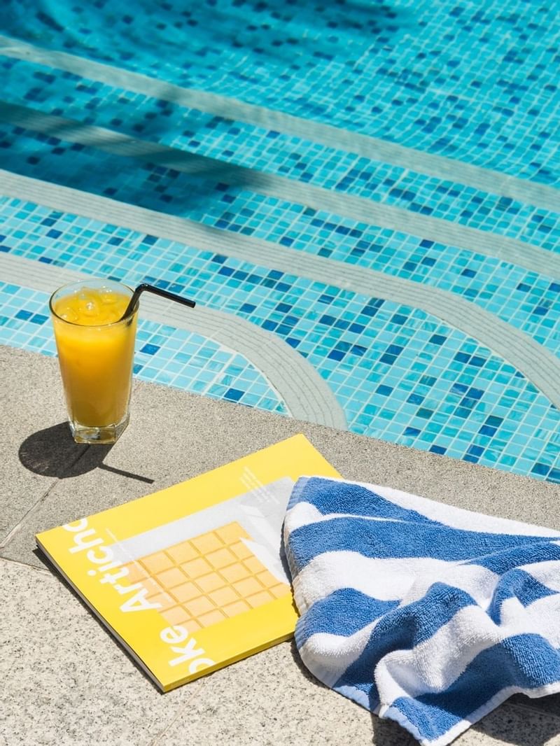 Close-up of a Juice & towel by the pool at Crown Hotel Perth