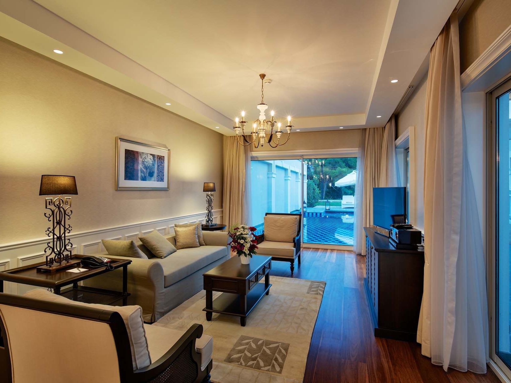 TV lounge area in Design Pool Villa with wooden floors at Titanic Deluxe Golf Belek