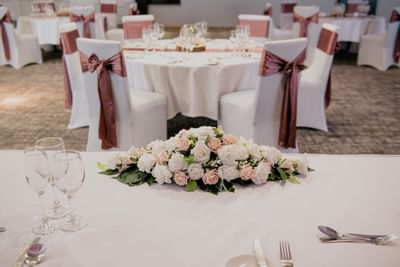 Ballroom wedding reception table at The Aberdeen Altens Hotel beautifully decorated with pink and white floral arrangements