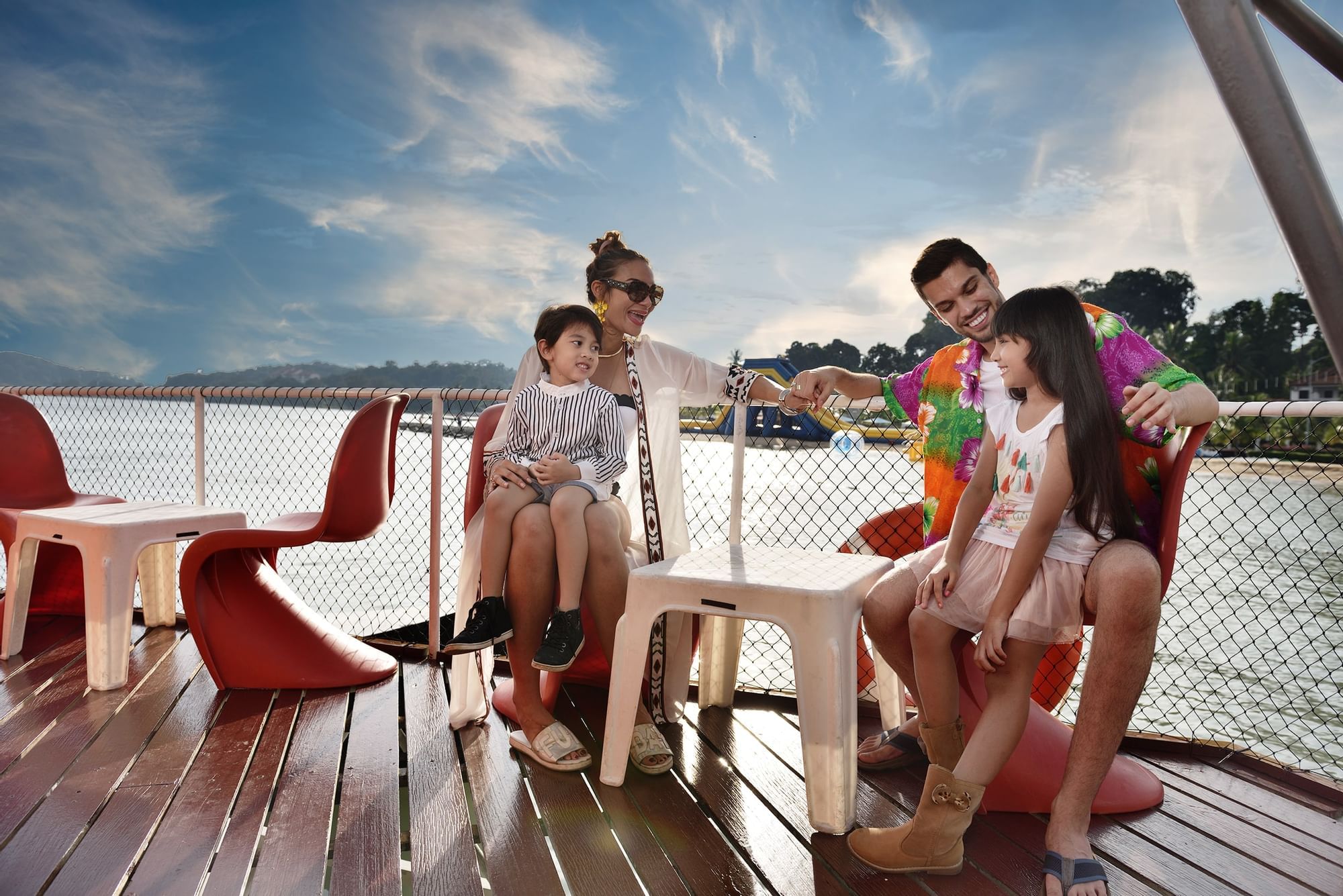 Family sitting near the beach on stools - Lexis Hibiscus PD