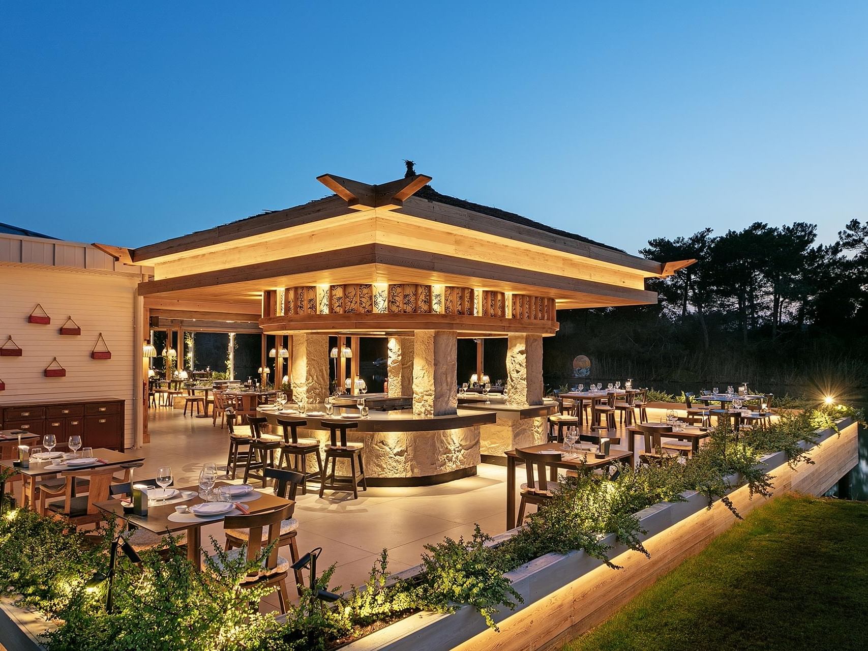 Teppanyaki Restaurant's dining area surrounded by greenery at Titanic Deluxe Golf Belek
