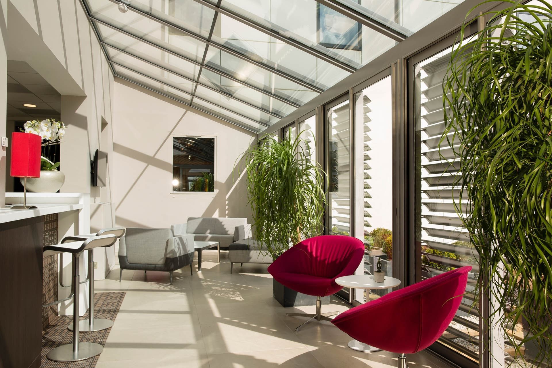 Lobby area with armchairs & open windows at Oceania Rennes