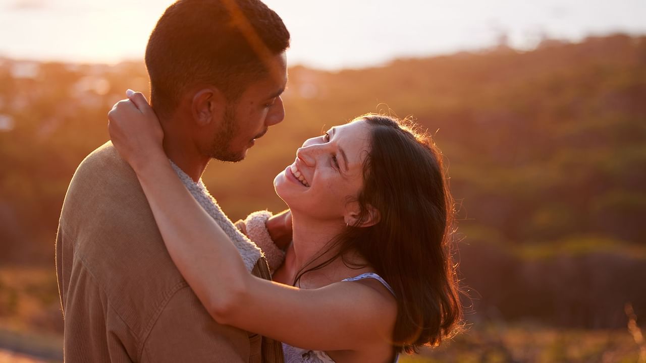A couple hugging under the sunset