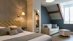 The suite room with a sofa at Auberge du Moulin a Vent