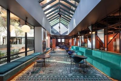 Lobby with carpeted lounge area at Amora Hotel Melbourne