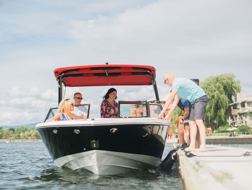 People getting into a boat at the dock near Manteo Resort