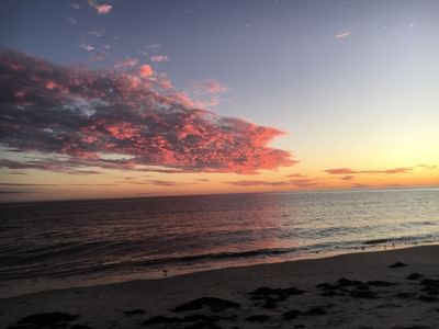 Scenic view of the sunset & vibrant orange and pink sky over the calm sea near Chatham Tides Resort