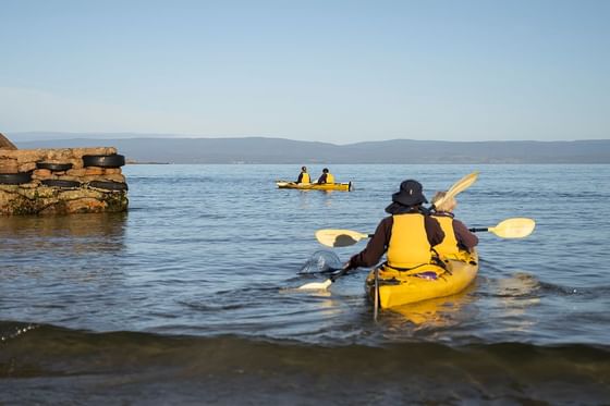 Landscape view of people kayaking on the Lake near Freycinet Lodge