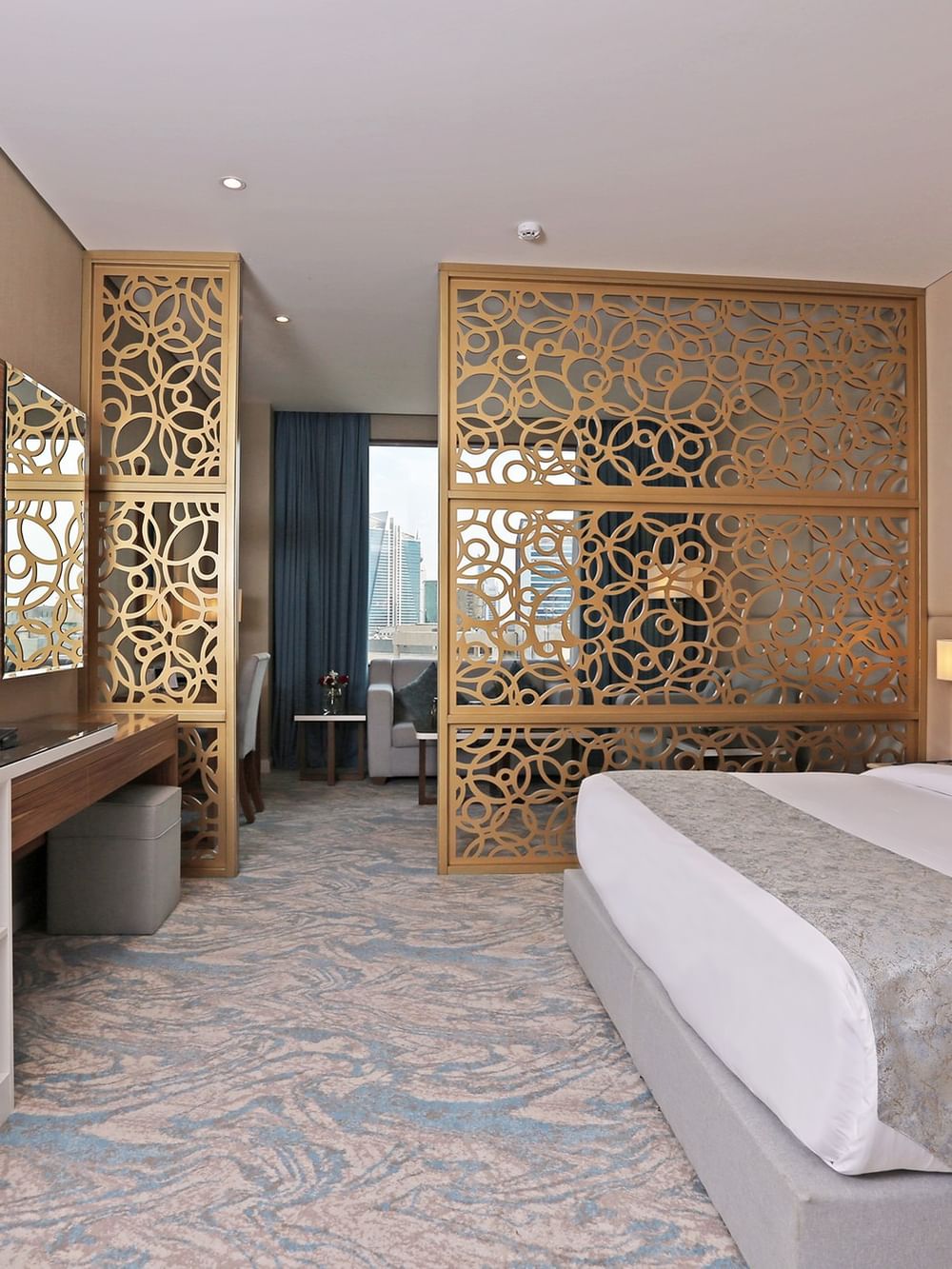 Elegant Junior Suite with a large bed, stylish decor, and city view at Cantonal Hotel by Warwick Riyadh.